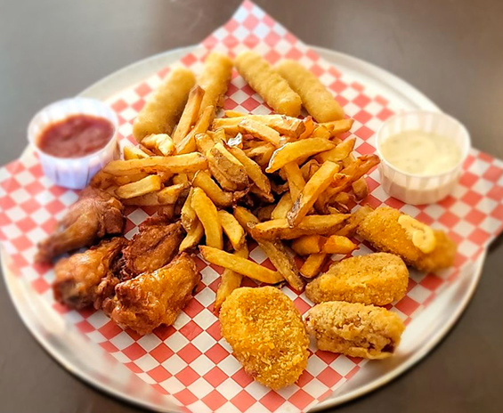 Appetizer plate with fries and sauces.