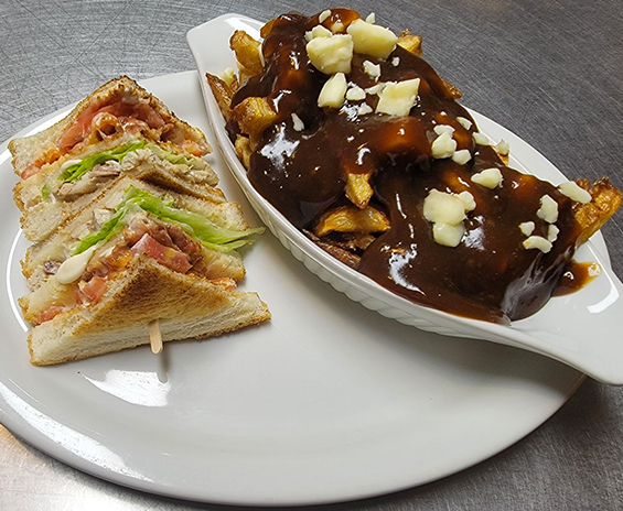 Club sandwich served with poutine.